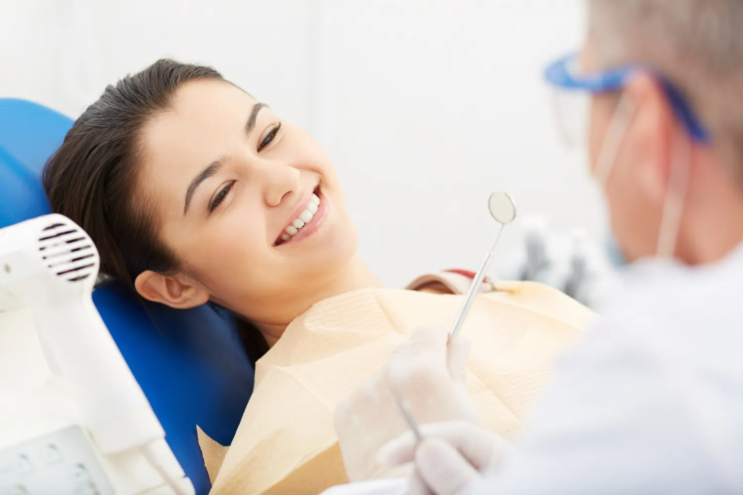 Patient smiling during dental check-up, showing that composite bonding doesn’t hurt.
